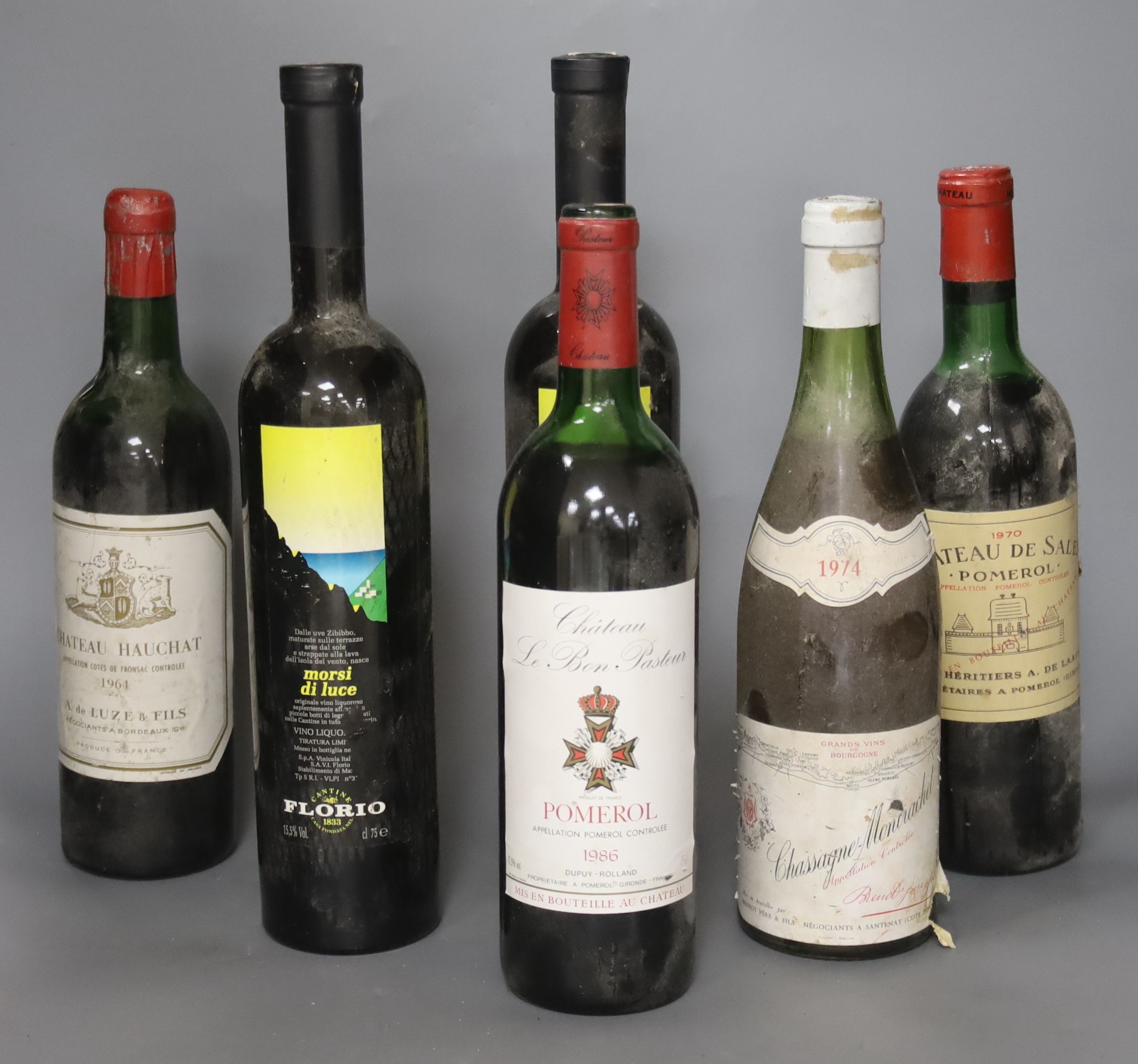 Three Bordeaux wines including Chateau de Sales, Pomerol, 1970, one e Bon Pasteur, 1986 and one Hauchat, 1964, together with one Chassagne Montrachet, 1974 and two Italian Morsi di Luce